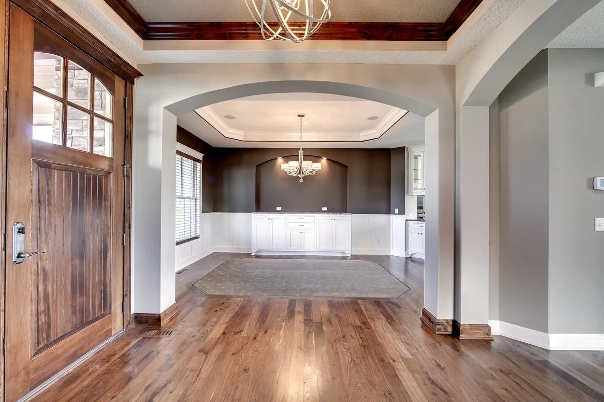 Full view of the dining area in dark gray and white wall color interior.