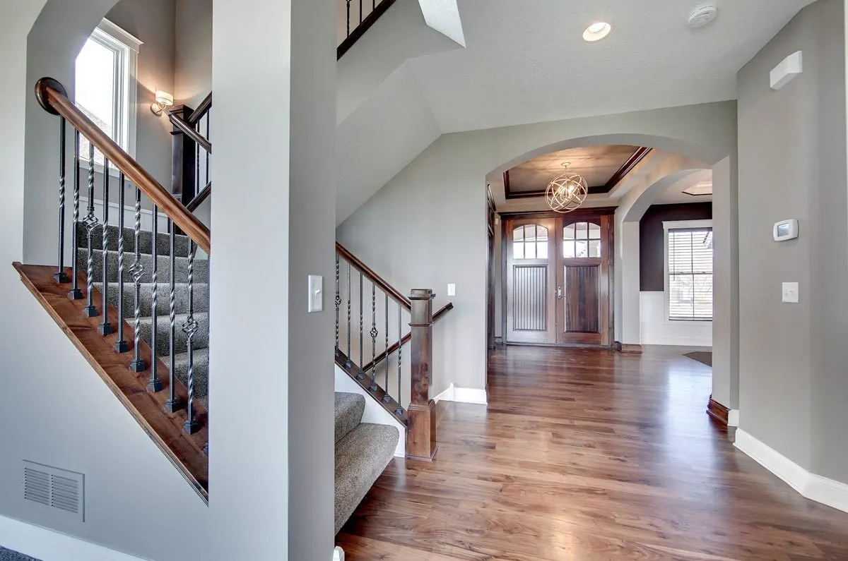 Gray interior paint complements the wooden door, railing, and floor.