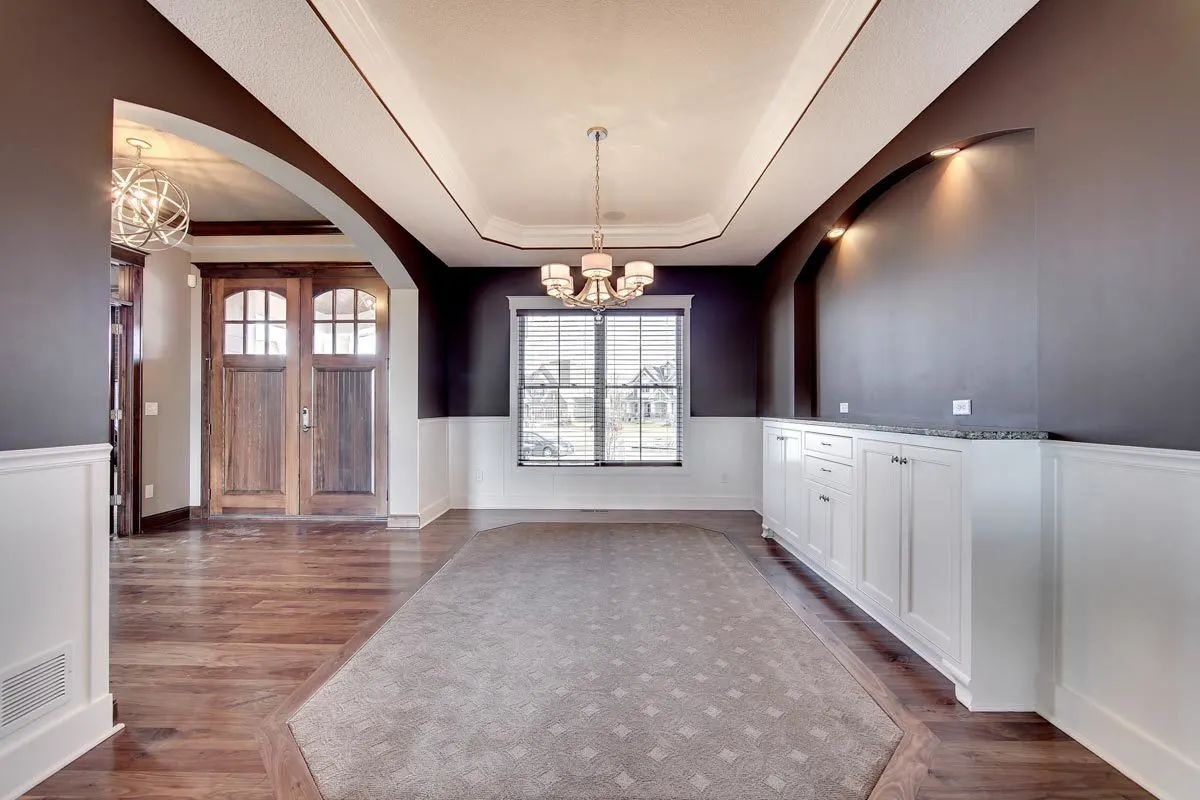 The white paint on the cabinet matches the hue of the wall.