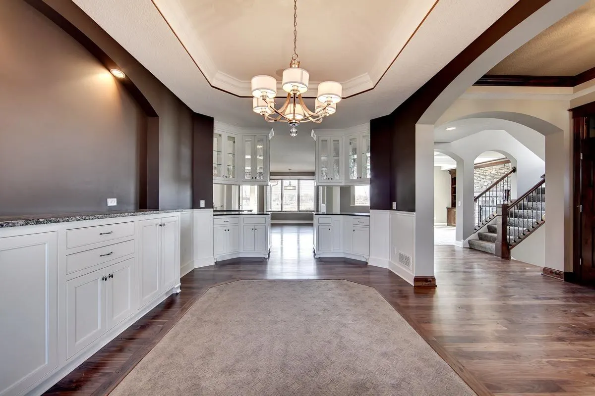 To divide the room, a hanging wall cabinet is installed near the kitchen area.