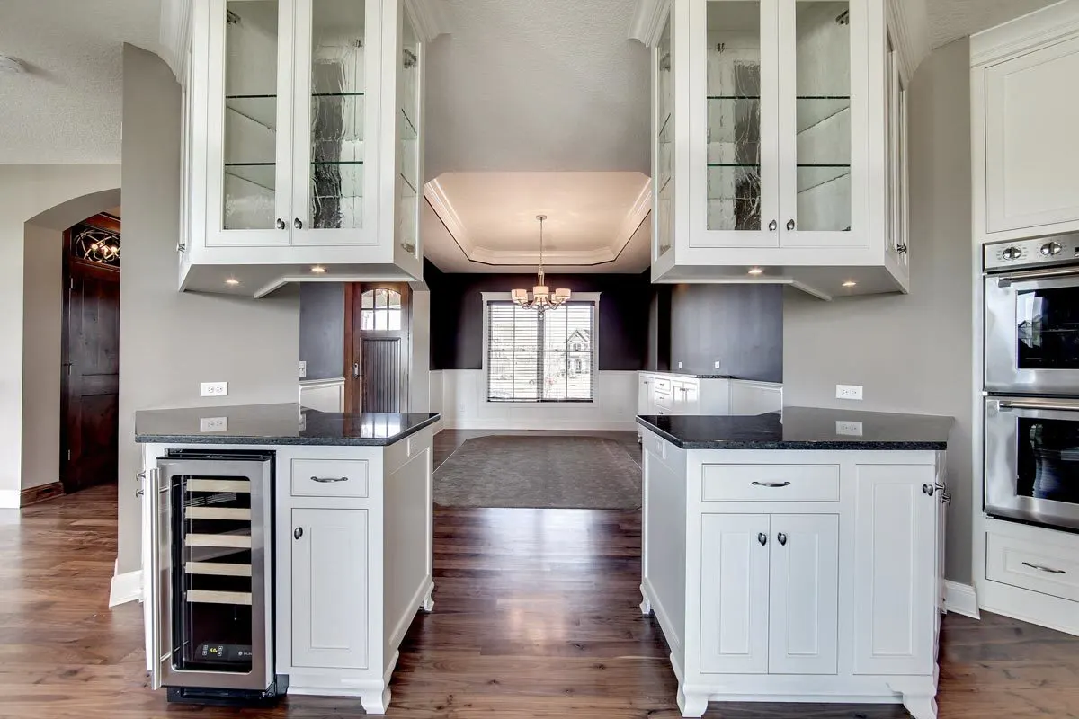A matching island on the angles with a black marble countertop.
