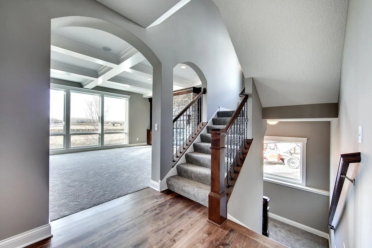 An up and down stair with a view of the great room area.