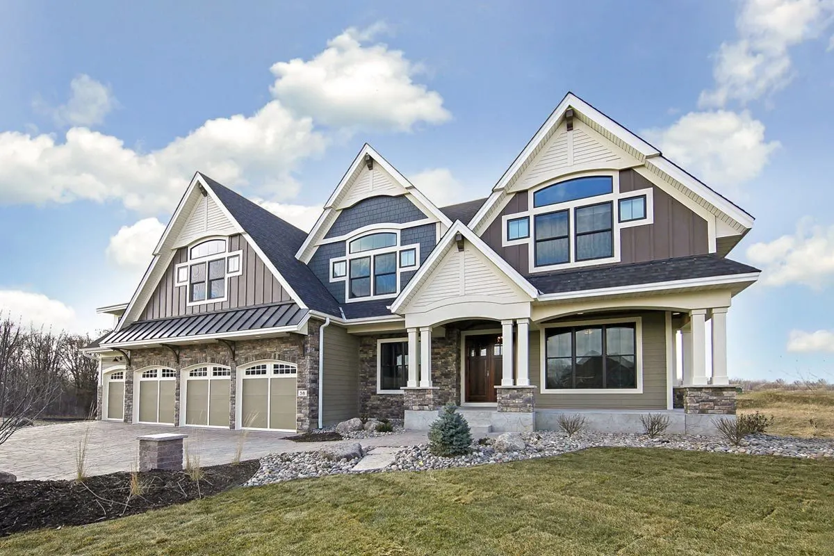 A side-angle picture of the house with a wonderful pattern of windows on the exterior.