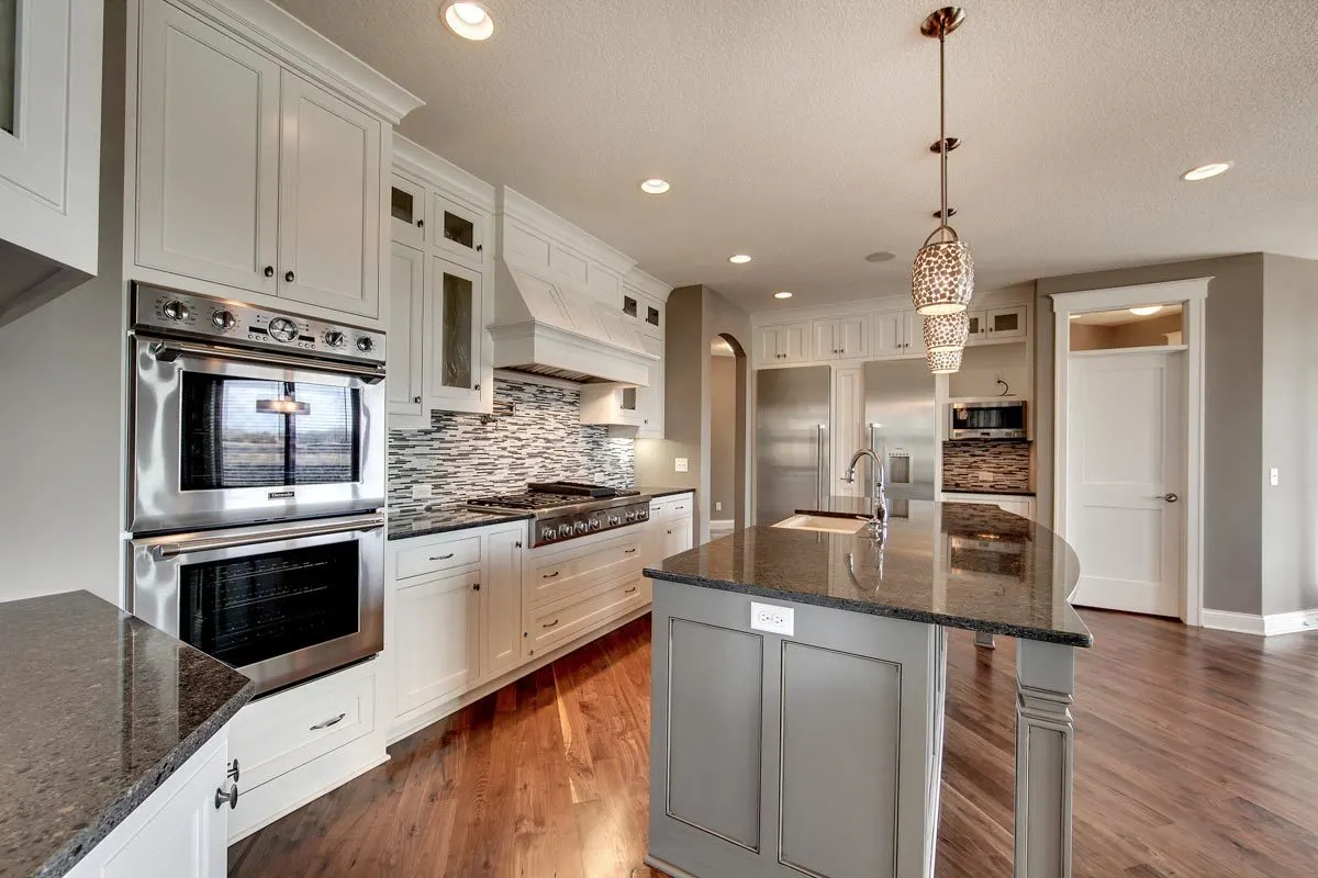 The kitchen has modern appliances and a gorgeous backsplash.