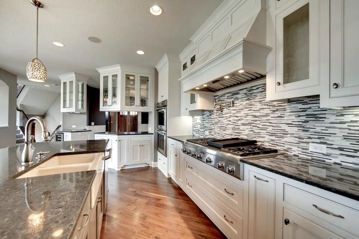 White sink and stainless faucet accent on the kitchen island.
