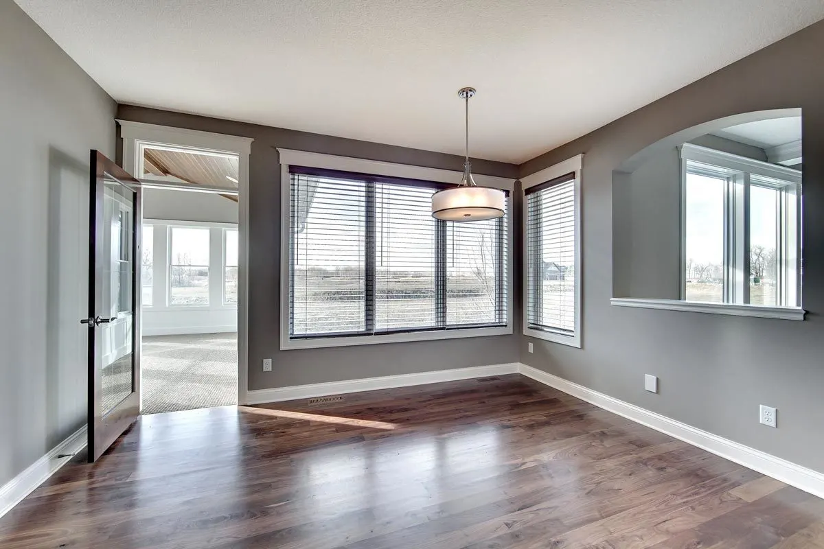 The 4-season porch has an open glass door with a wood frame.