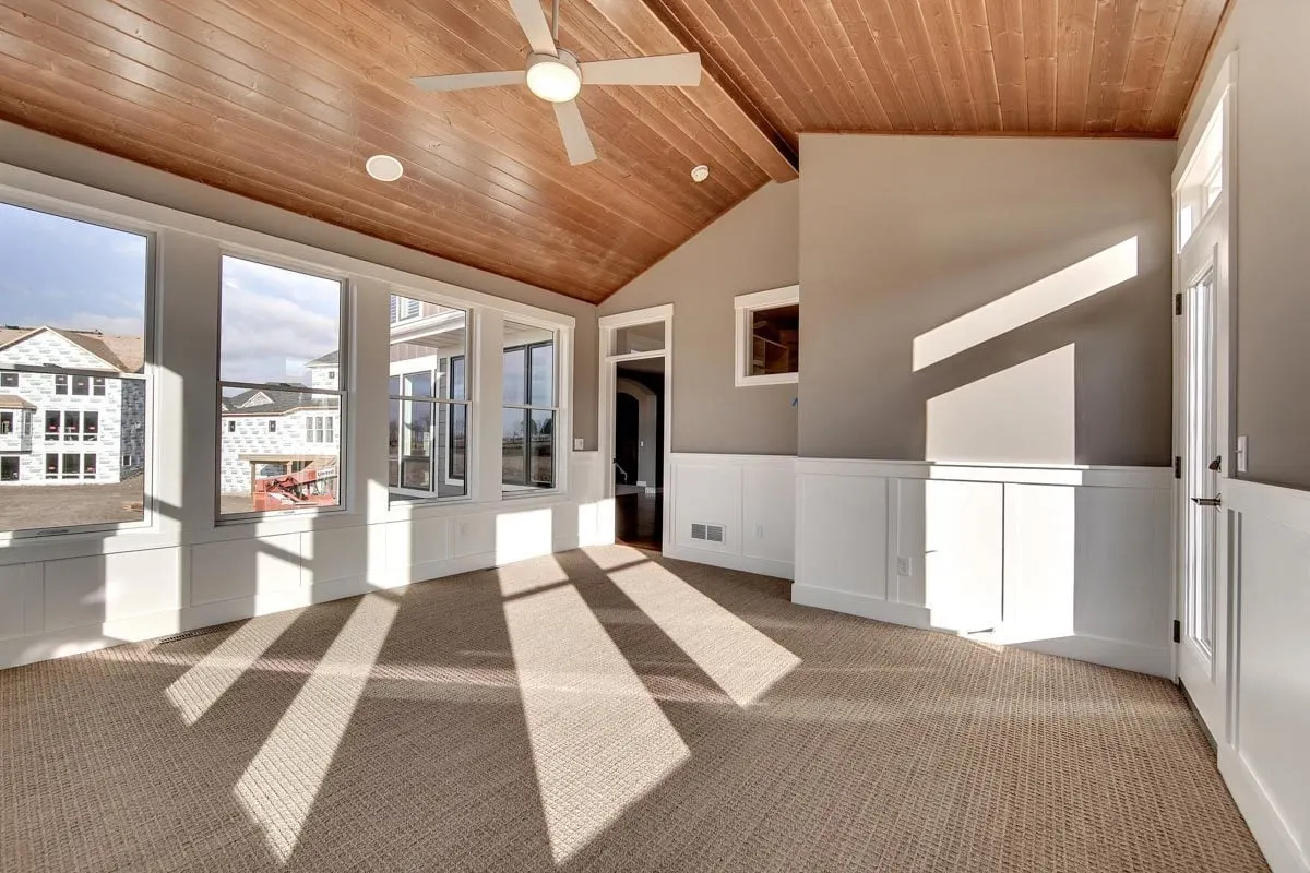 Half of the wall is painted in gray with a ceiling fan feature.