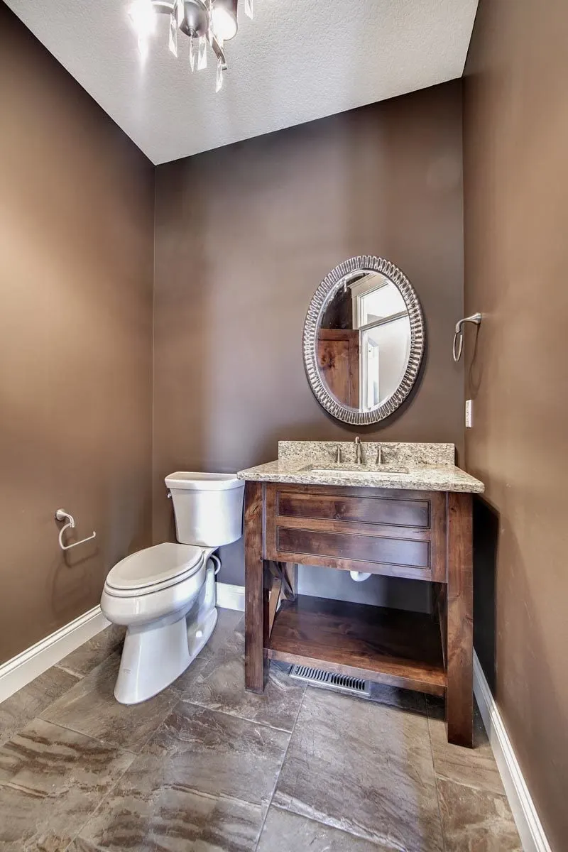 A powder room with a mirror in an exquisite style.