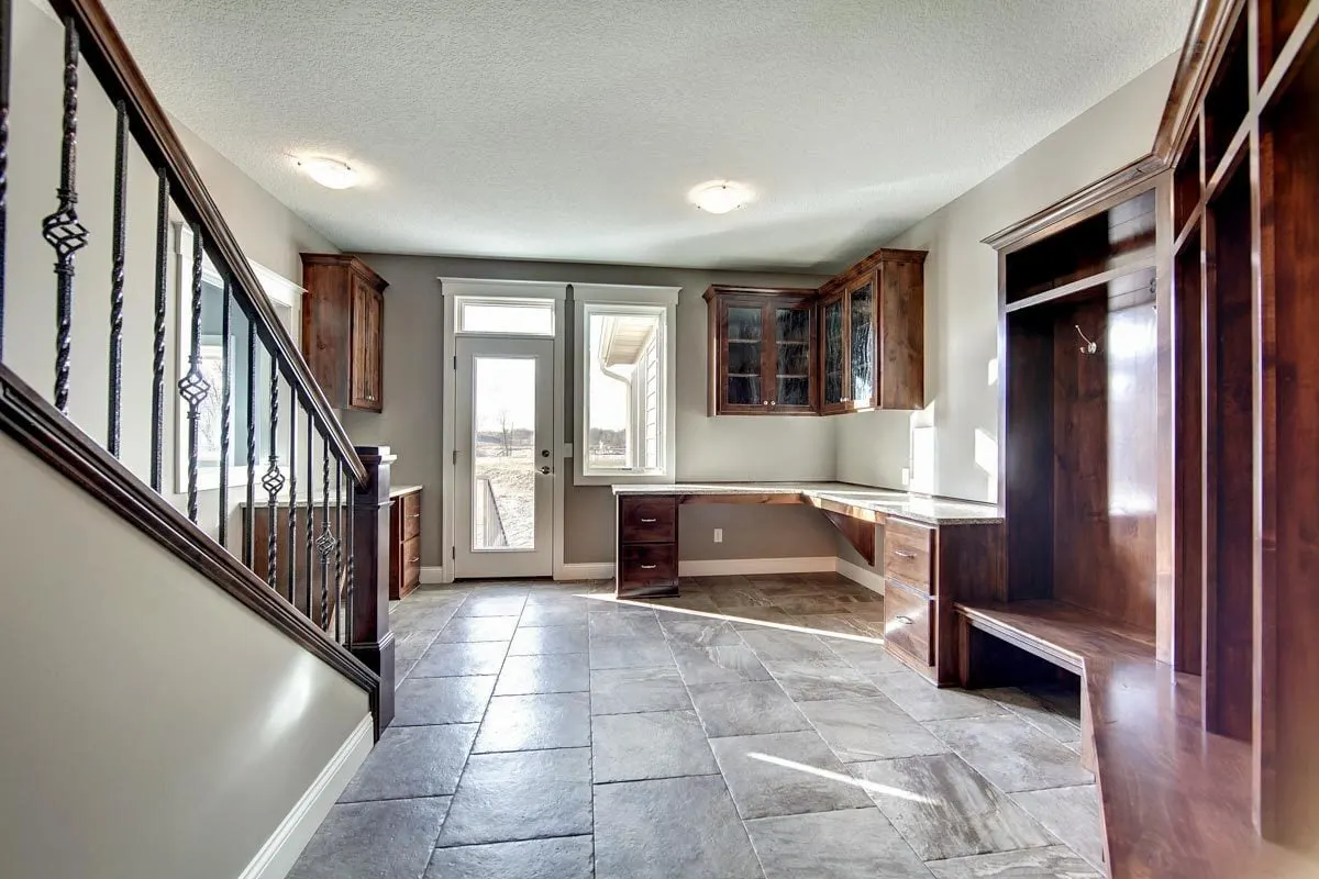 Mudroom with racks and hanging shelves in an elegant wood style.