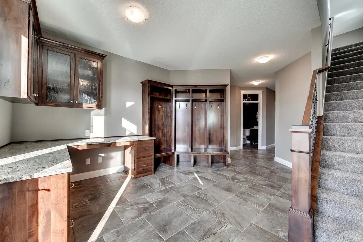 The mudroom's floor is covered with a compact stone tile.