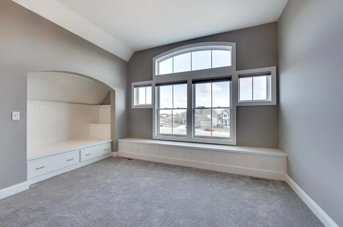 Bedroom area features bed nooks in white painted wood with drawers.