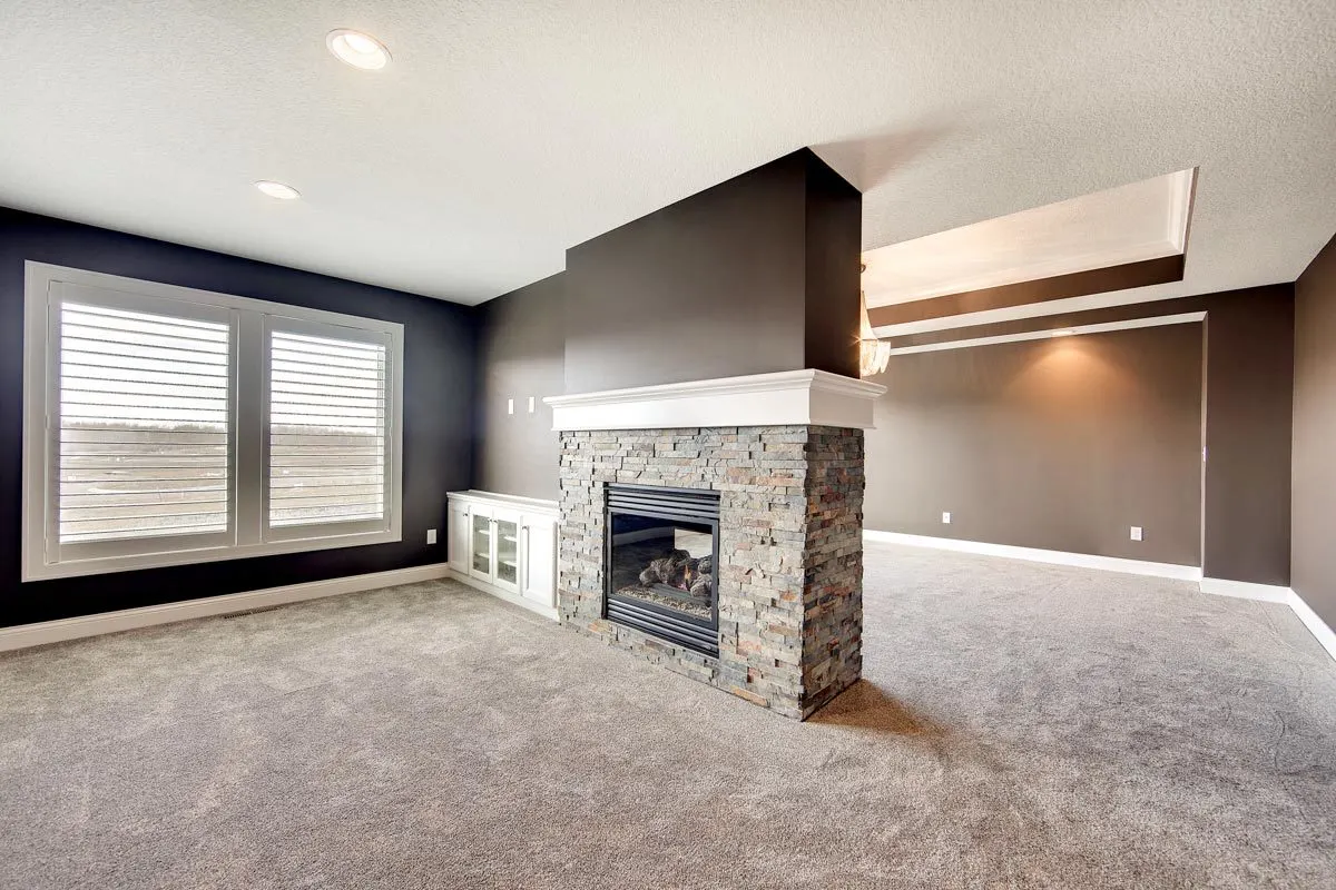 Sitting area with a fireplace in a brick stone base.