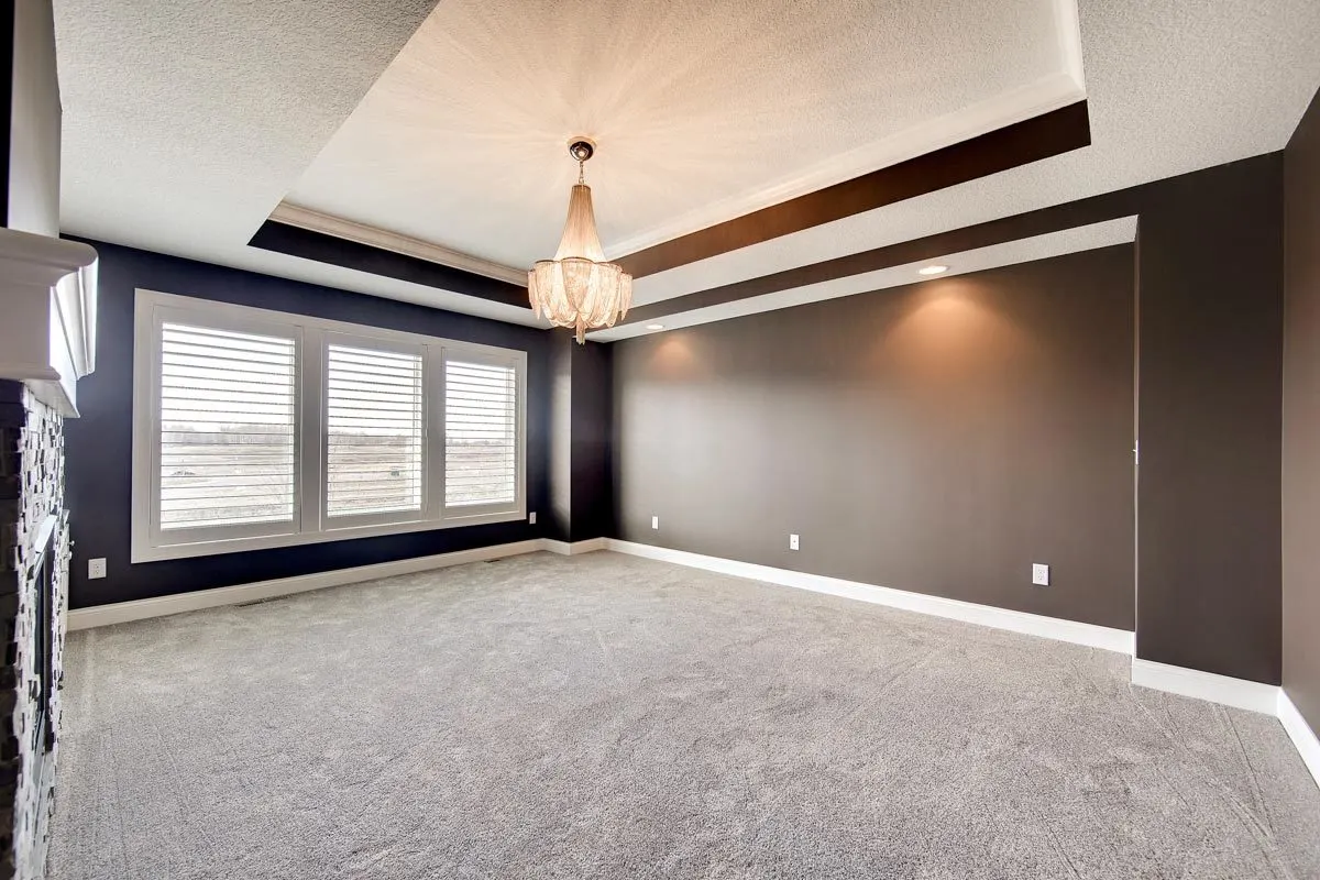 The master suite features a large three-window layout with dark gray walls.