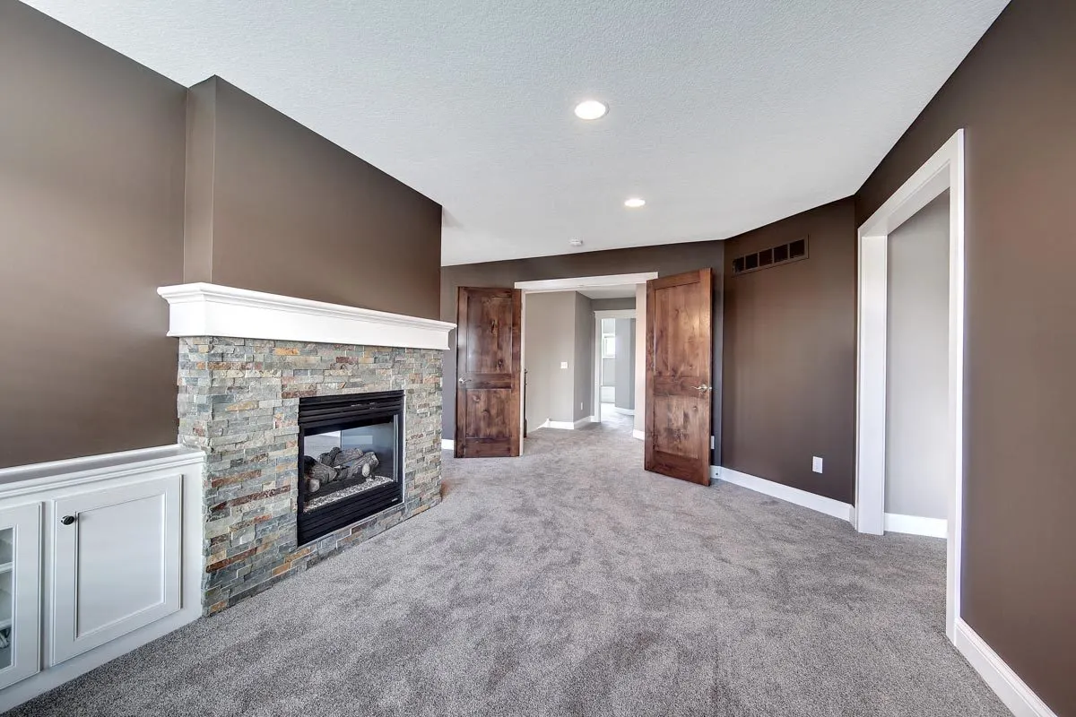 The sitting space is completed with a double door with a wood accent.