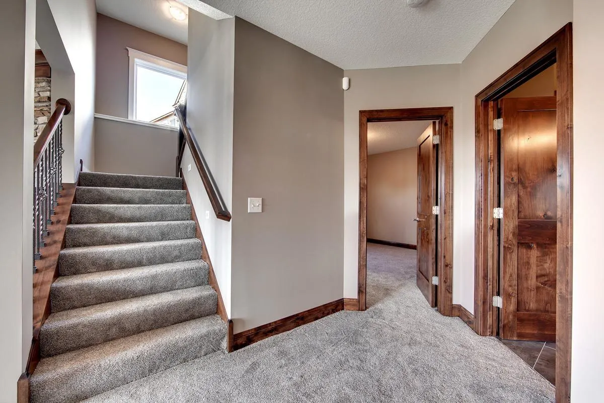 A carpeted staircase leading to the ground level.