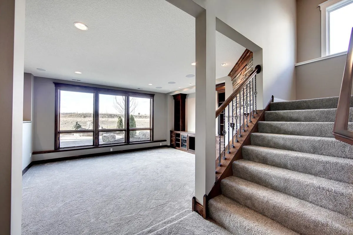 Glance of the lower level's large window layout with wood accent trim.