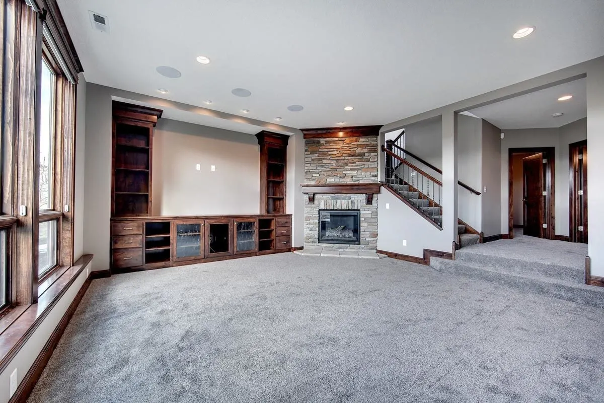A solid wood entertainment center is available near fireplace.