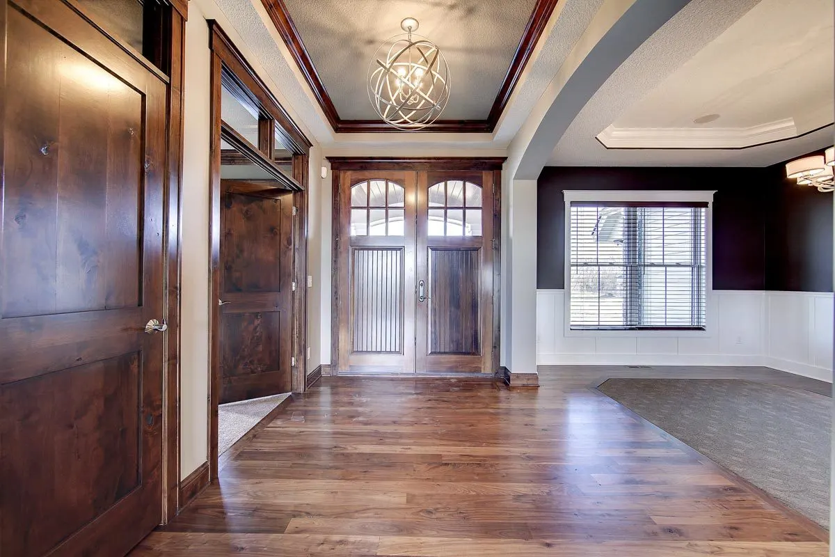 The house's entryway has a wood accent design with double doors.