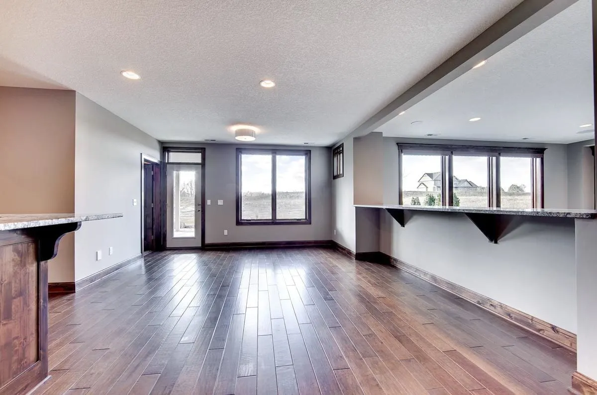 Game area with a wood pattern floor and an entrance to the outside.