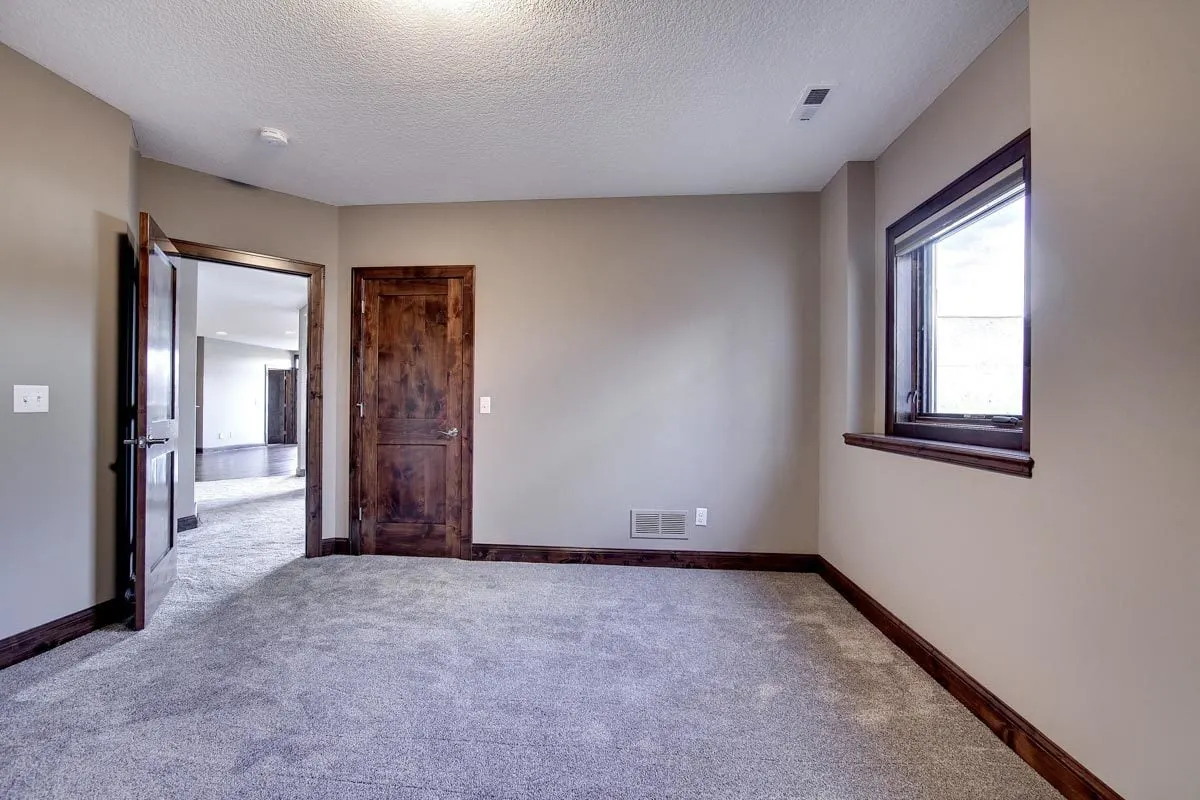 A wooden door entrance to the bedroom closet.