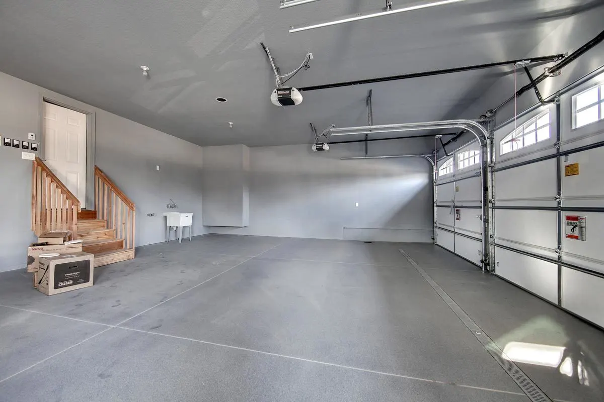Spacious garage space with a door to the mudroom.