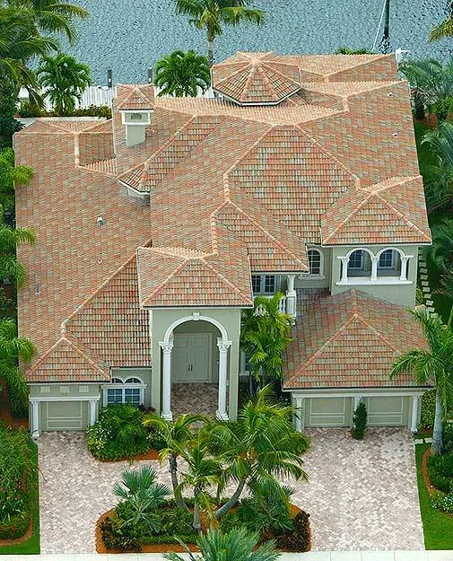A traditional Mediterranean exterior with a magnificent roof and light green paint walls.