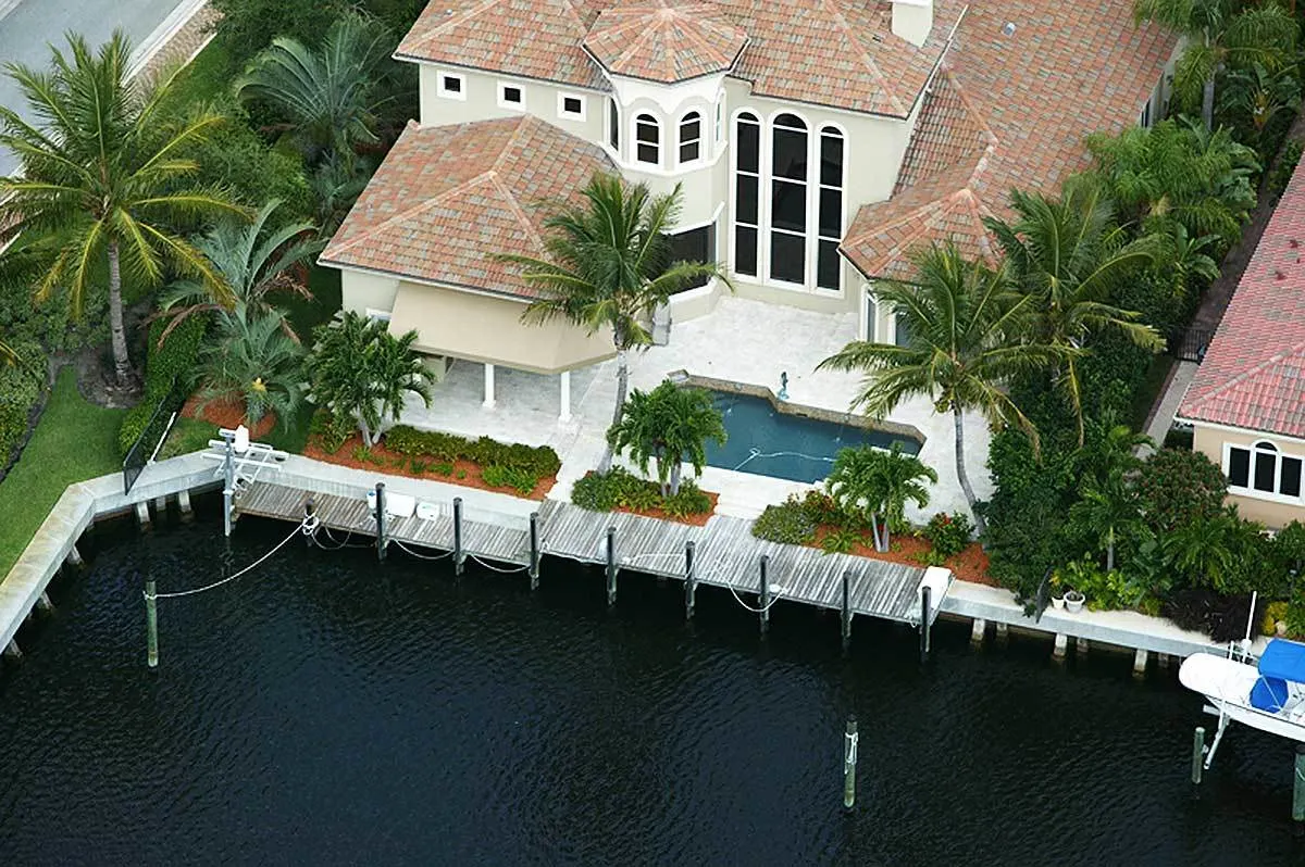 Pool area and long dock space can be seen in the back of the home.