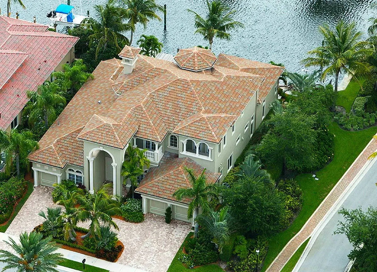 The garage is visible in front of the home on both sides, and the front entry is designed with lofty ceilings.