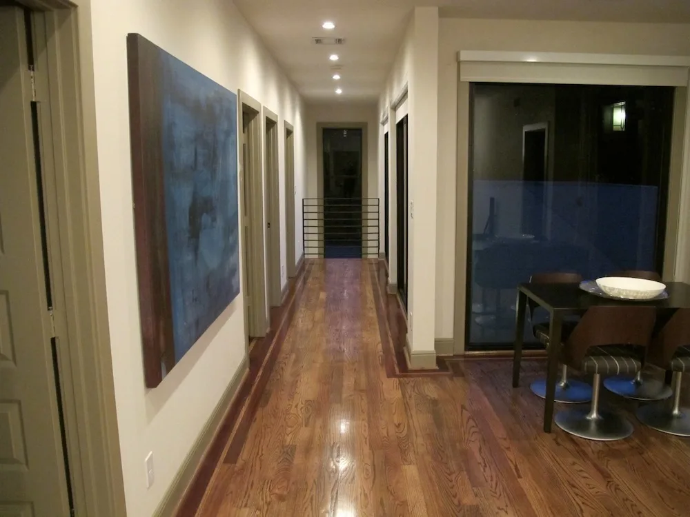 The second-level hallway has a wood-polished accent floor.