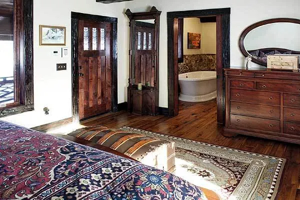 Master bedroom area with a dark accent wood style and bath feature.