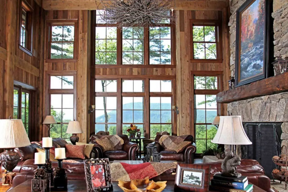The rustic living room's dark brown leather sofas and simple lamp designs go nicely together.