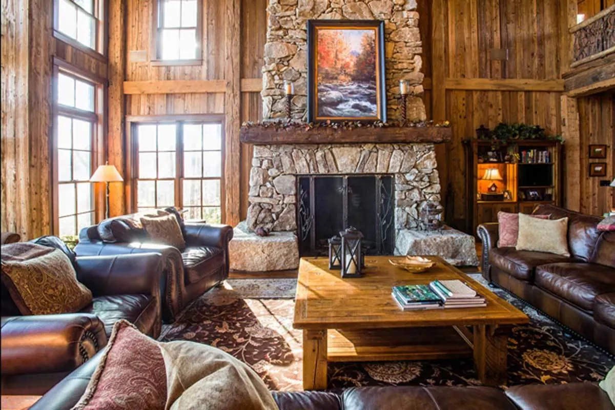 Stone-built fireplace area with a black-framed panel cover.