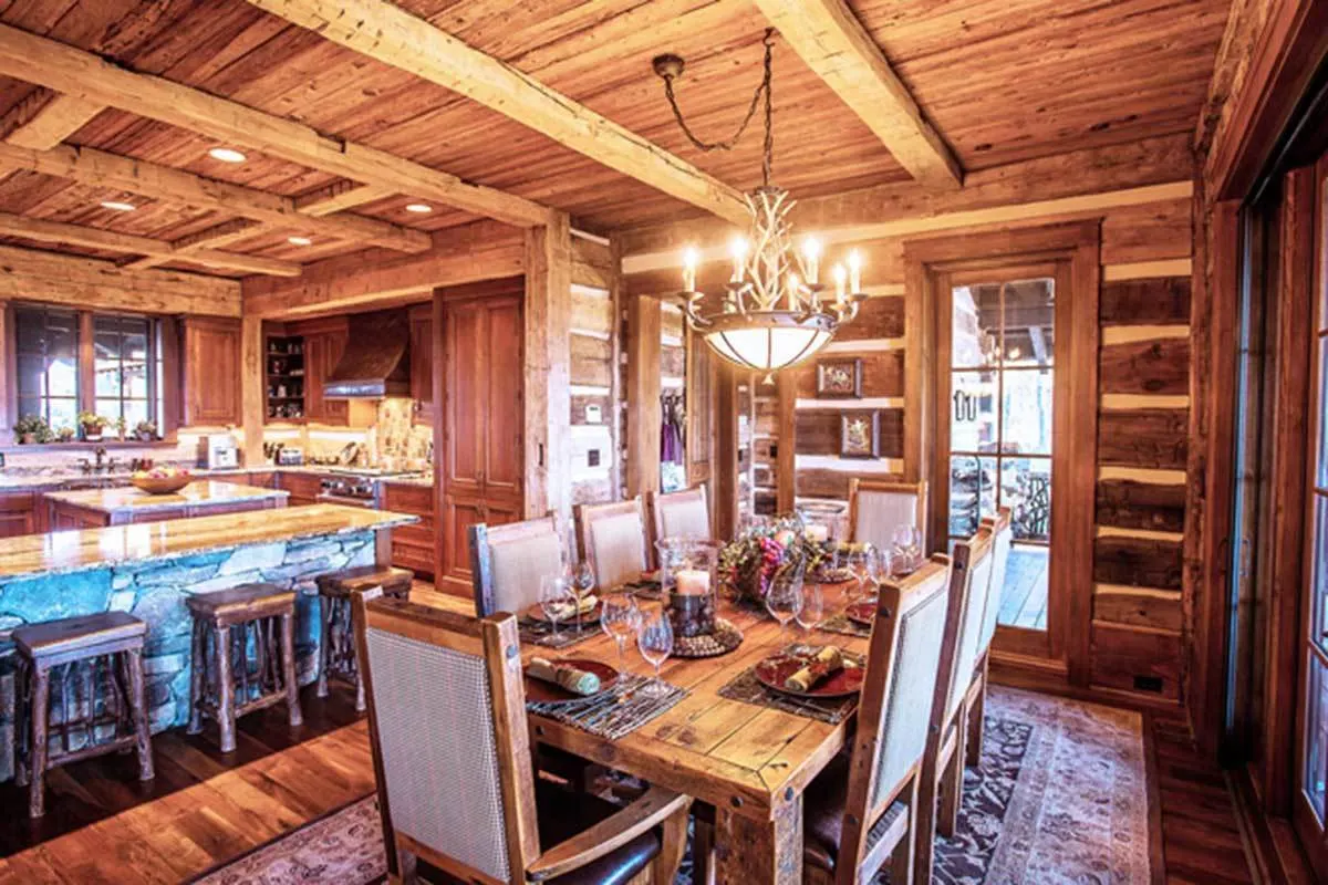 Elegant dining area with an 8-seater chair and table and candle chandelier above.