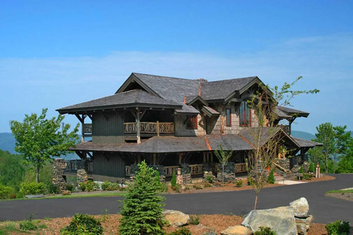 A dark-colored mountain home view from the left side.