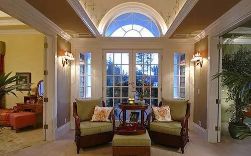 Sitting space with a white door, window, and decorative glass frames.