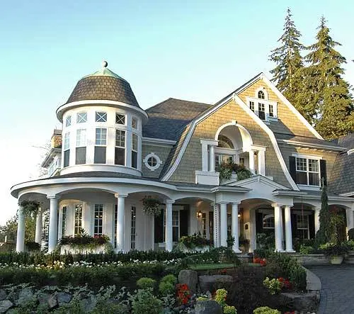 The house's magnificent gambrels, columns, and gables in the shingle style stand out on the exterior.