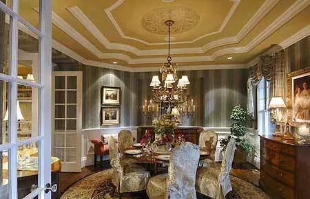 Luxurious dining space with a table set and a bright chandelier.