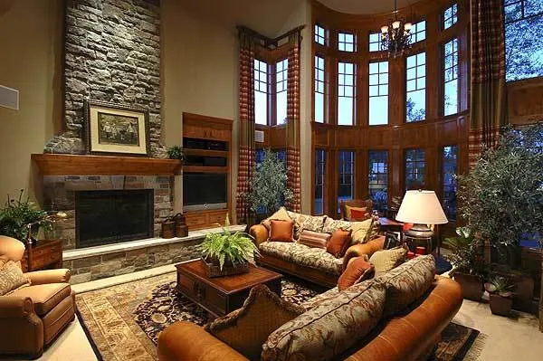 A stone-framed fireplace is accessible in the living room area.