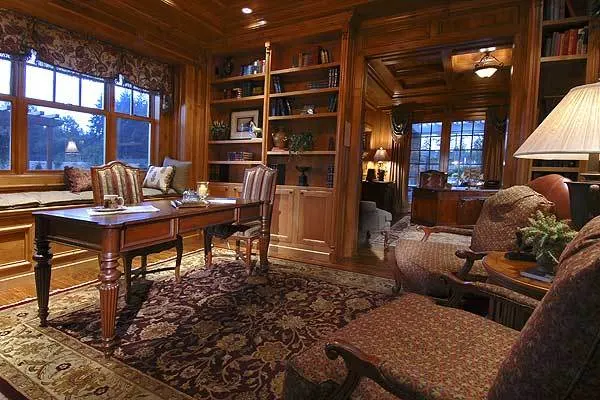 Study space with a table and chairs and an elegant wooden accent design.