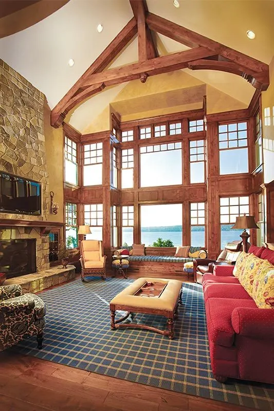 The living area with wooden framed windows and a high ceiling.