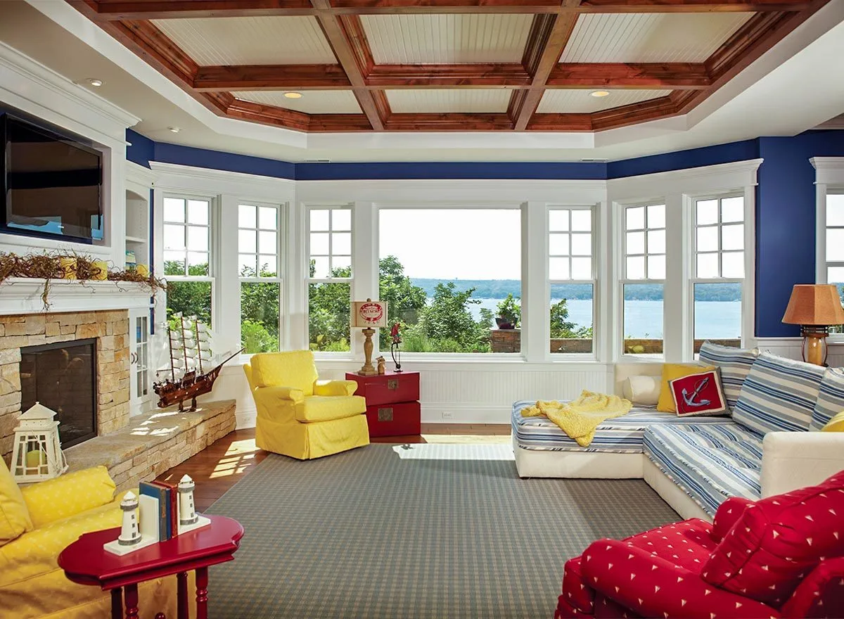 A 1980's inspired interior design on the second floor with a wall-like windows and tray ceiling.