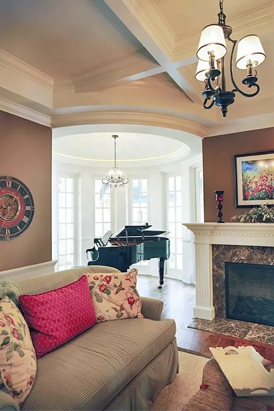 An entertainment space where there are darts, fireplace, and a grand piano.