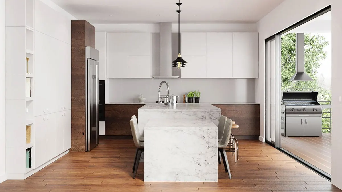 Stylish white indoor kitchen with grill space viewable on the covered deck.