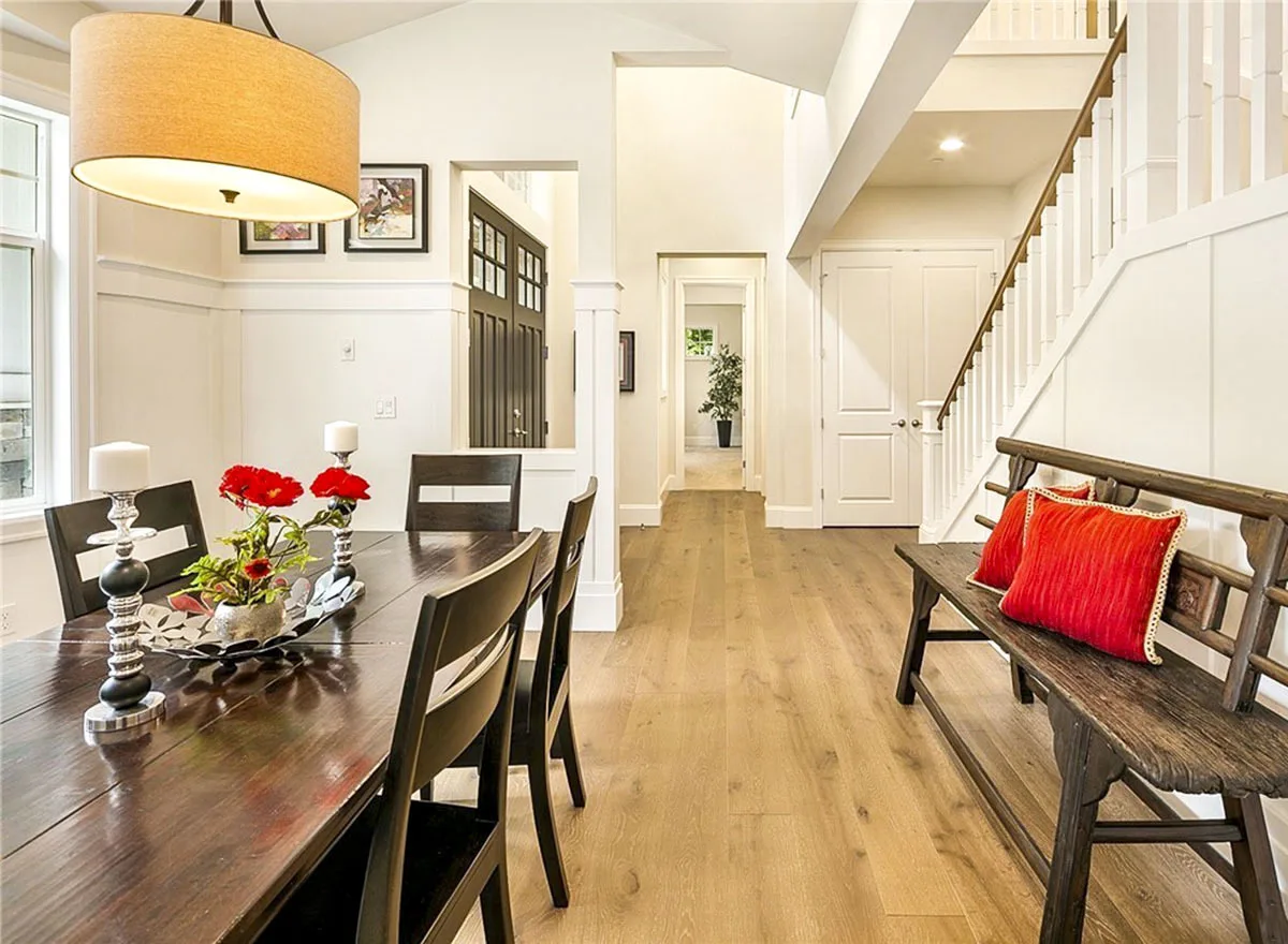 View of the dining area adjacent to the entryway with wood accent floors.