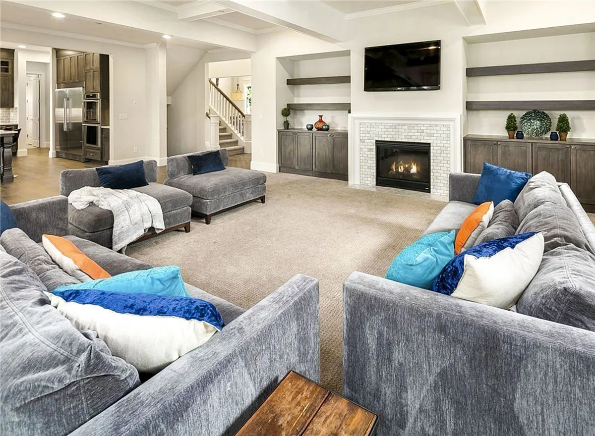 The living area features a fireplace with a gray cabinet and rack on both sides.
