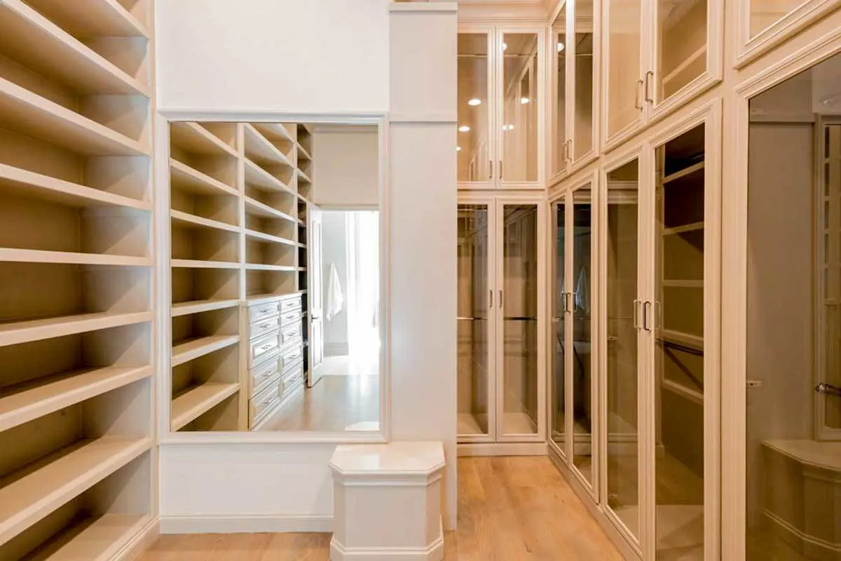 In the closet, a wall mirror and a modest stool are added.