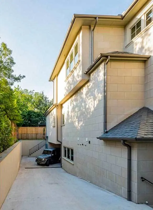 The drive-under garage section in the house's left side wall.