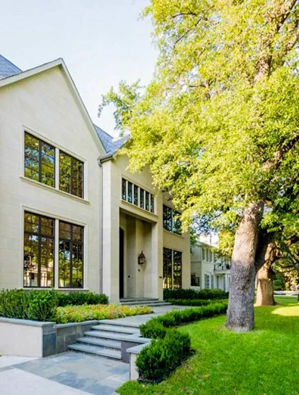 A stone tile walkway from the front door decorated with plants offers curb appeal and a great view.