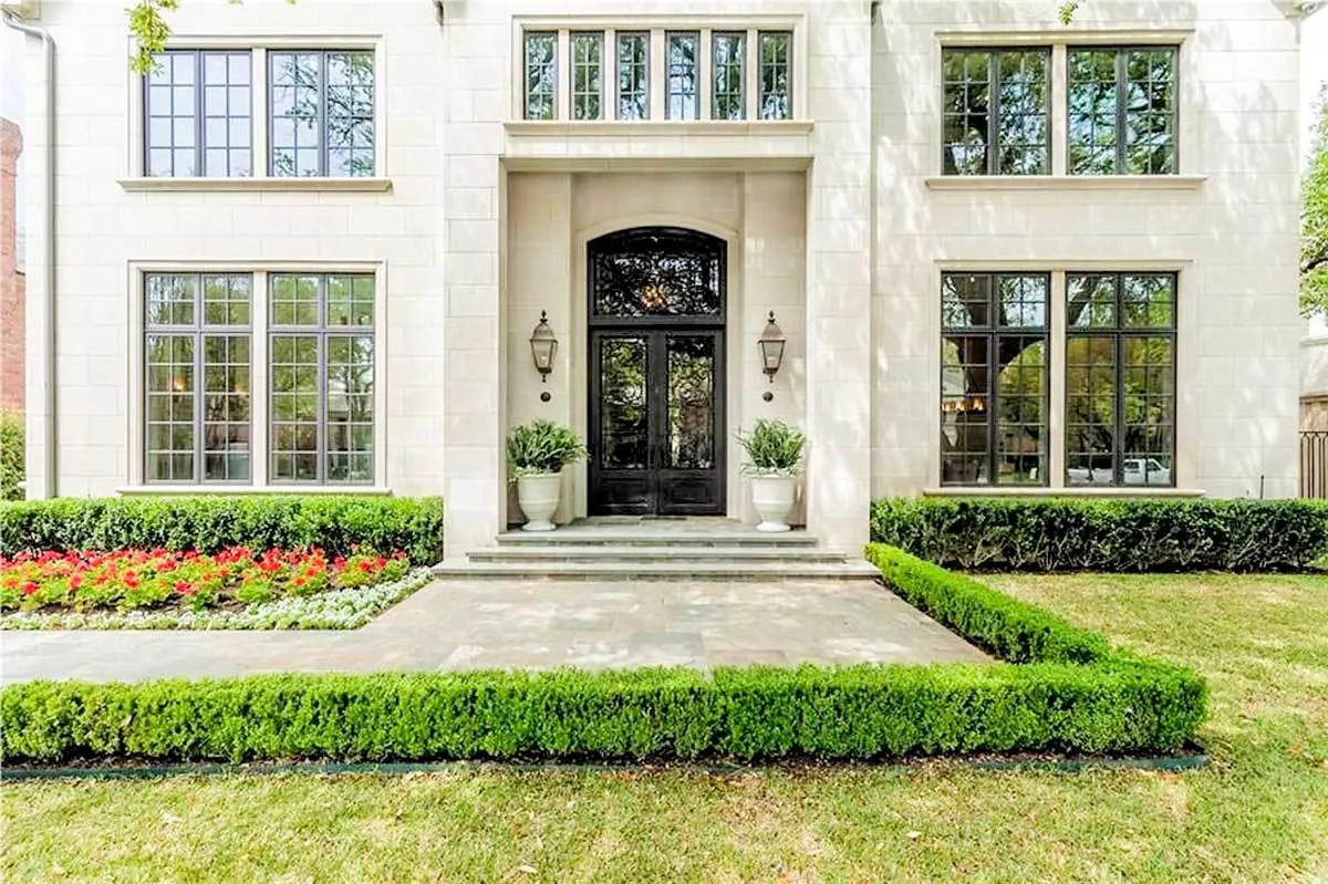 The window with a black trim pattern style provides a wonderful view of the front of the house.