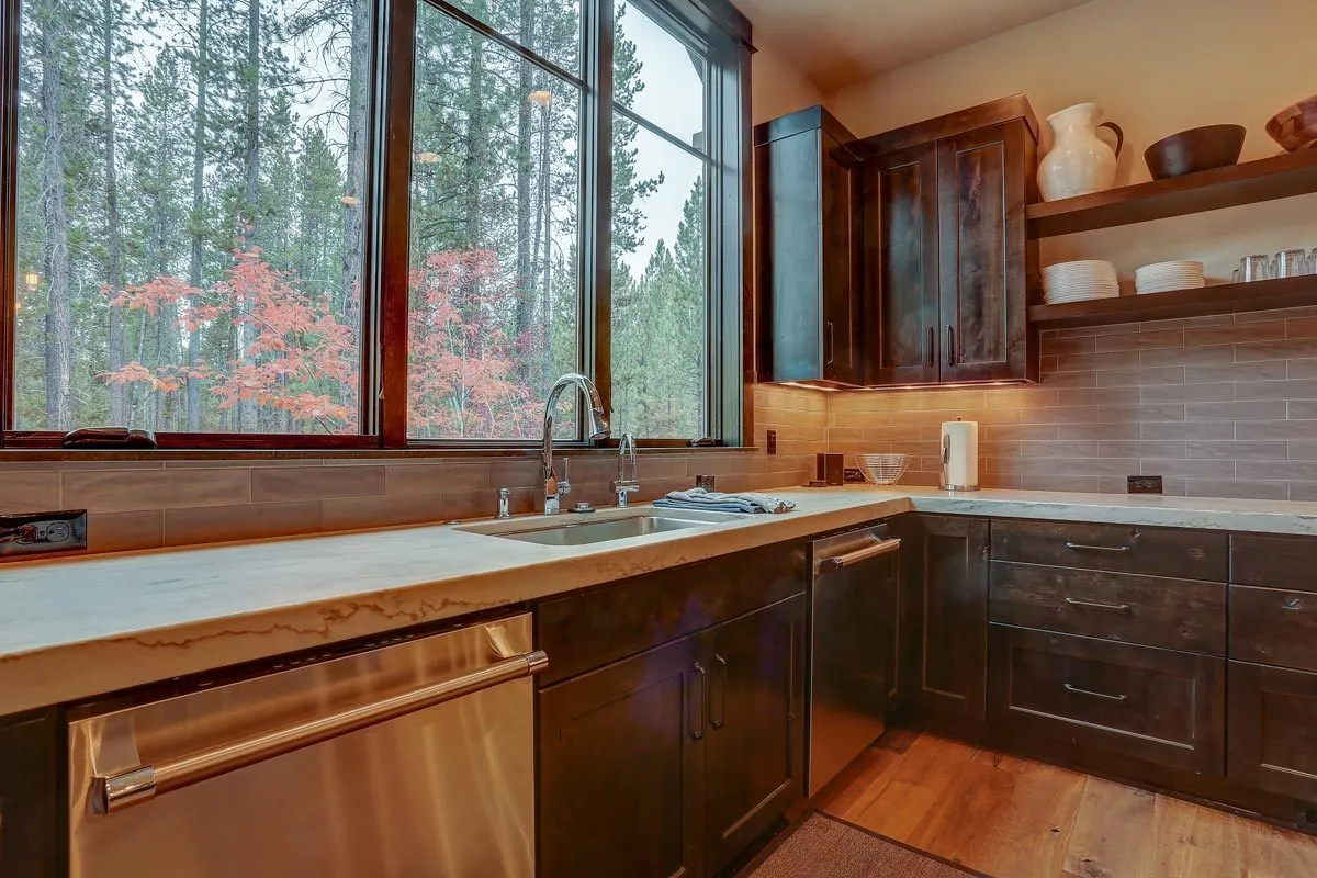A large window glass offers lighting and a glimpse of the outdoors to the kitchen.